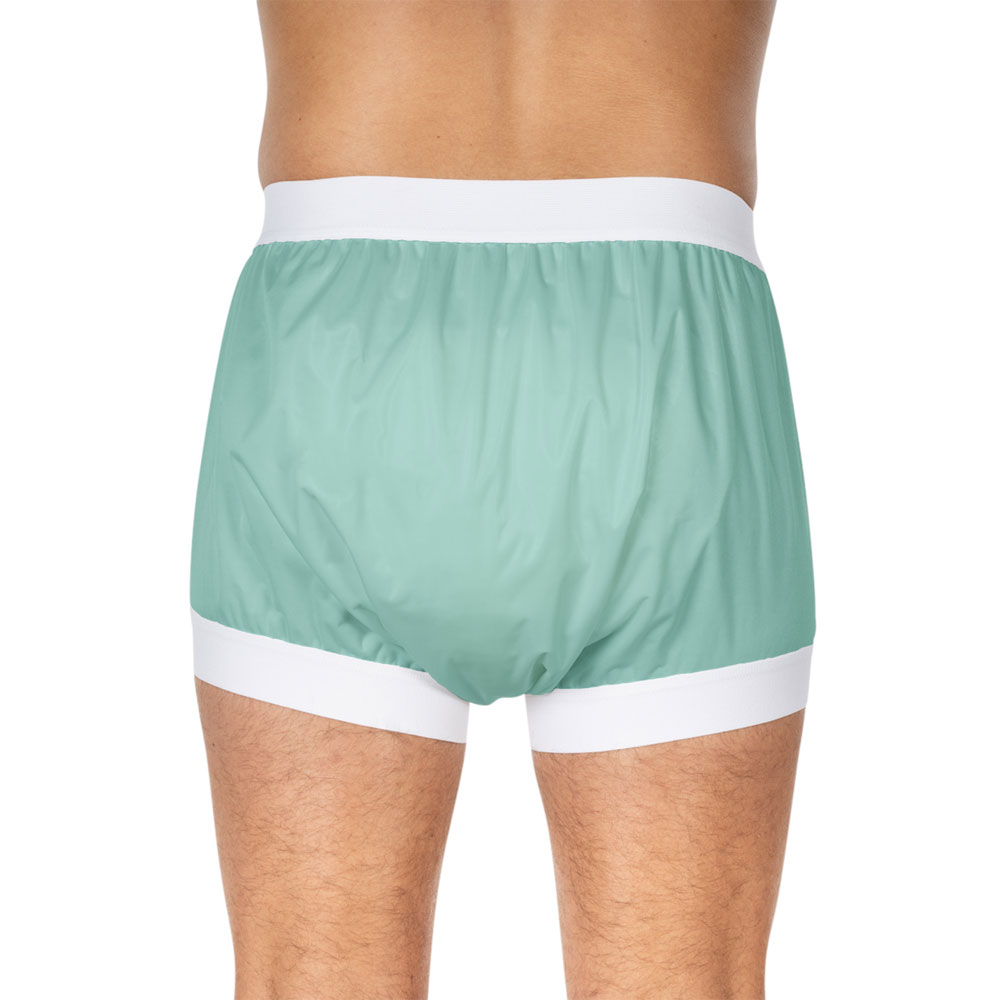 Grüne, elastische Pants mit breitem, weißen Gummibund und Beinabschlüssen werden von einem Mann von hinten getragen, der nur den Oberkörper sichtbar hat. Der Hintergrund ist neutral und unauffällig.